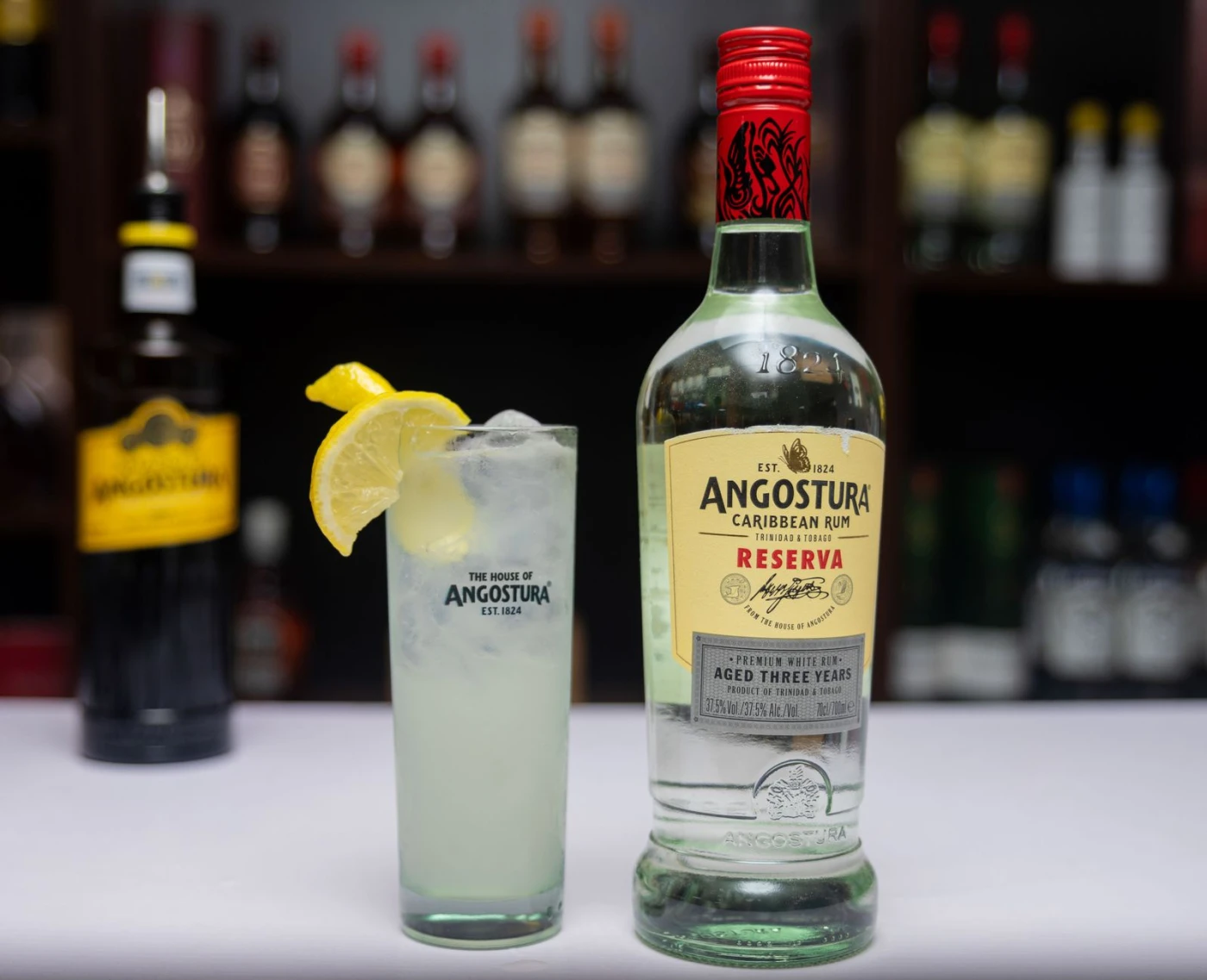 Ace Of Clubs Daiquiri ingredients with rum bottle and bar tools