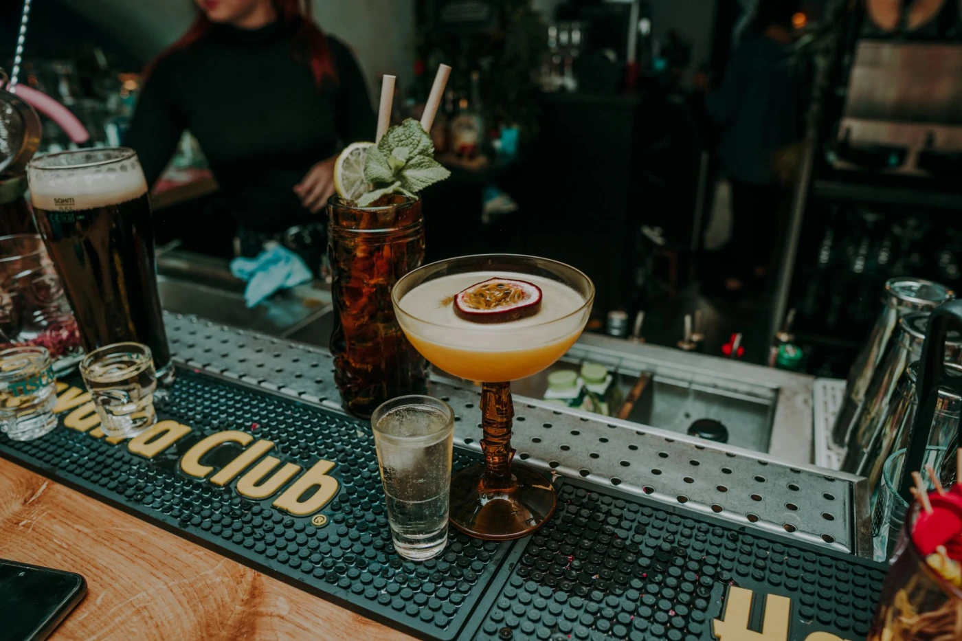 After Eight ingredients with cocktail bottle and bar tools