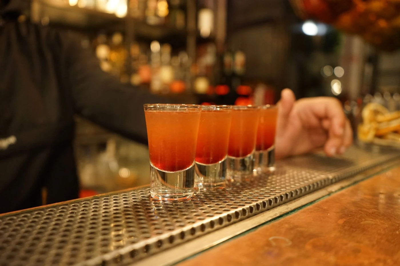 After Six Shot: Colorful cocktail shots ready on a bar counter, capturing nightlife and bar atmosphere.