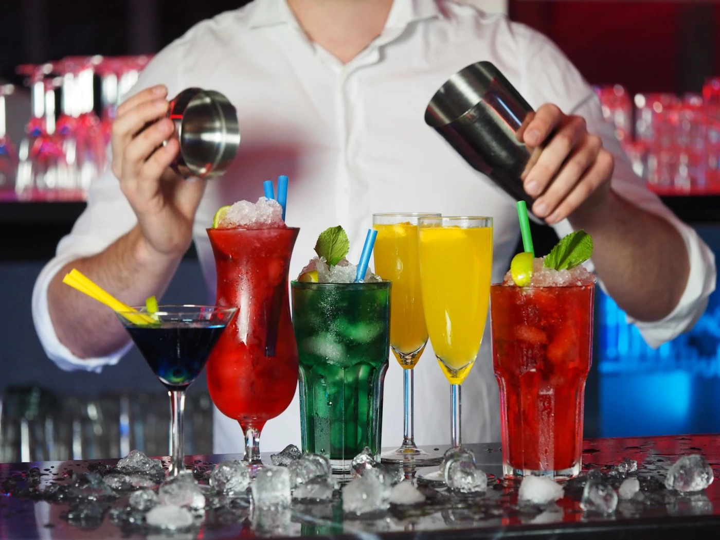 Bartender preparing an Alabama Slammer cocktail in a shaker