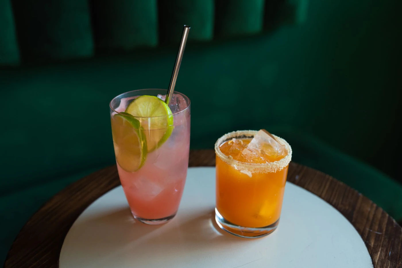 Alabama Slammer (straight-up) ingredients with cocktail bottle and bar tools