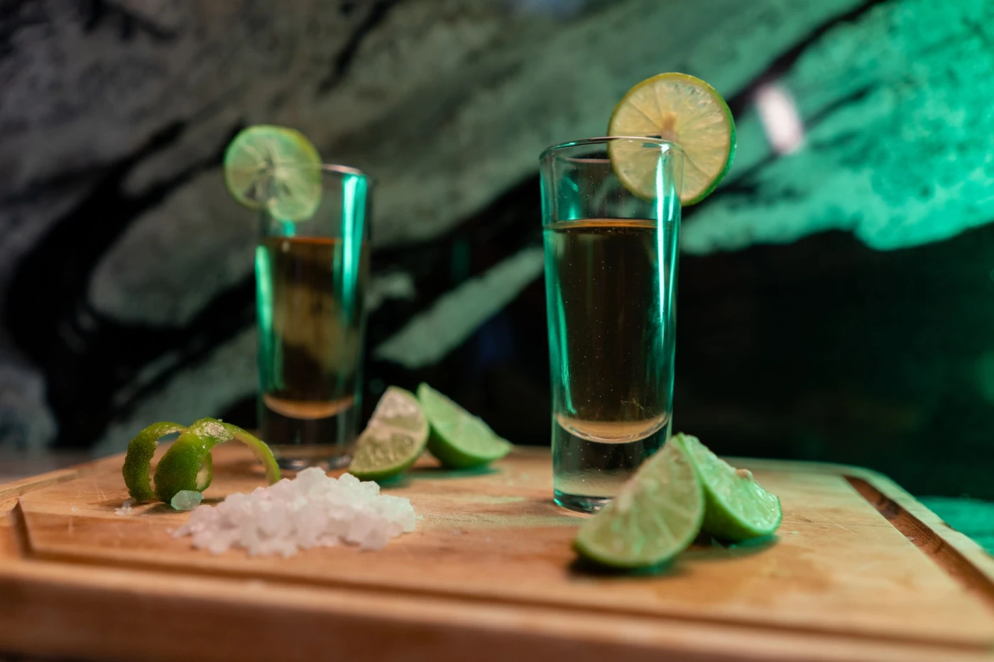 Batanga Tequila and Coke Cocktail: Refreshing tequila shots with lime wedges and salt on a board, perfect for parties.