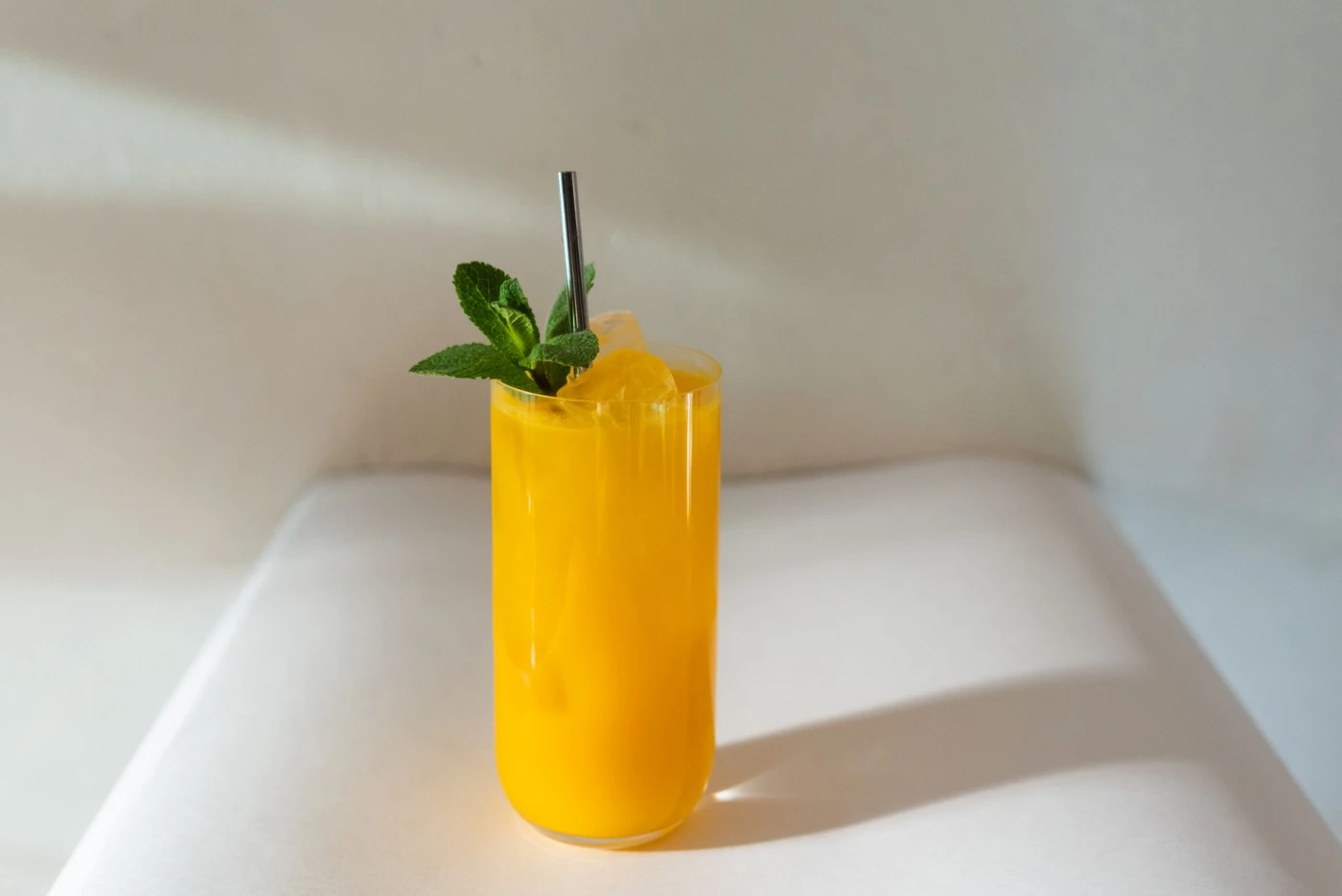 Best bunny burrow: a tropical mango and carrot mocktail cocktail served in glass with ice