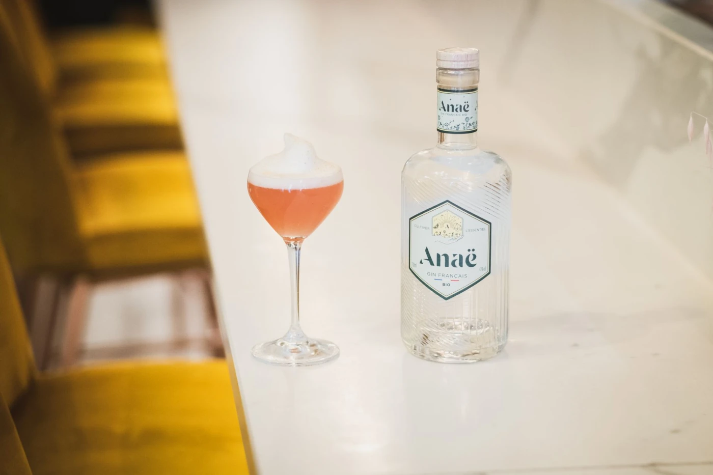 French 75 cocktail with Cognac ingredients with gin bottle and bar tools