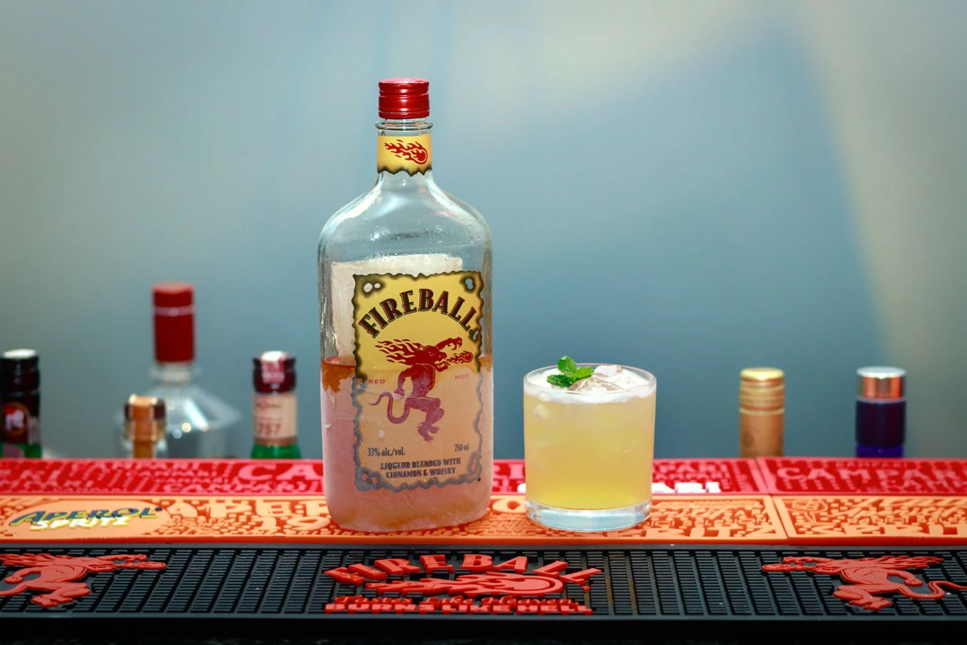 Homemade Cinnamon Whiskey: Still life of Fireball whiskey with cocktail on a bar counter in Recife, Brazil.