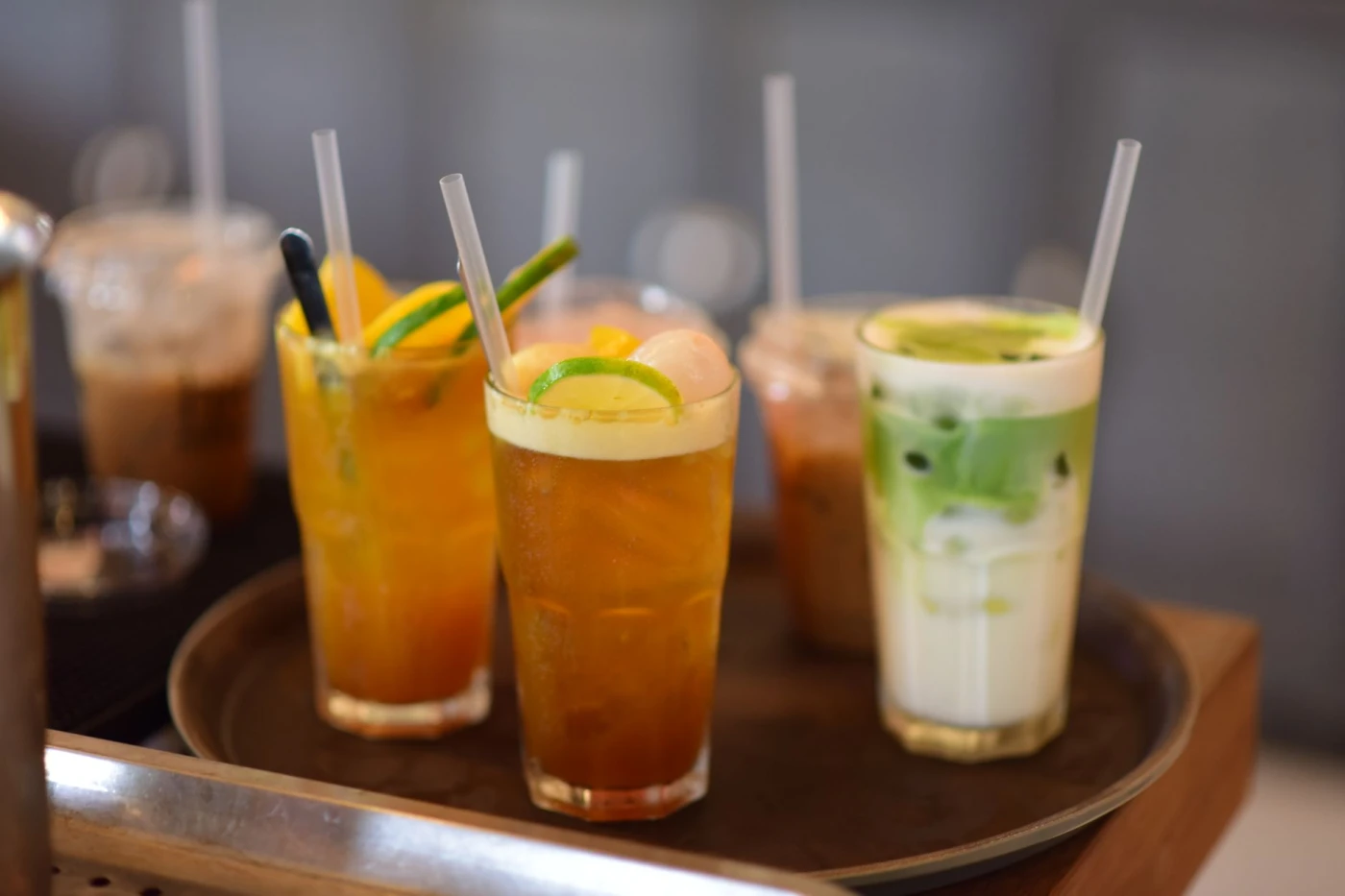 Long Island Iced Tea: A variety of iced drinks including tea and matcha latte served on a tray, perfect for cooling down.