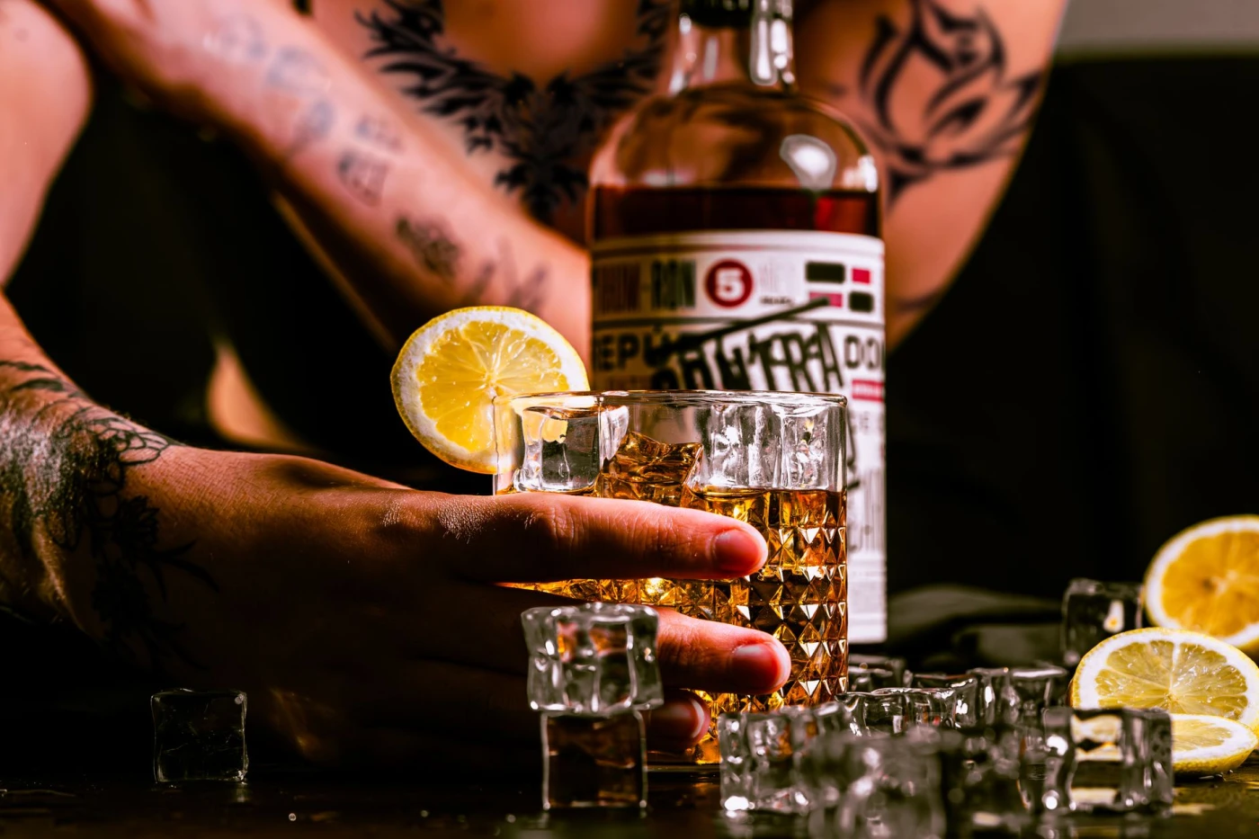 Person holding an Oaxaca Old Fashioned in a nightlife setting